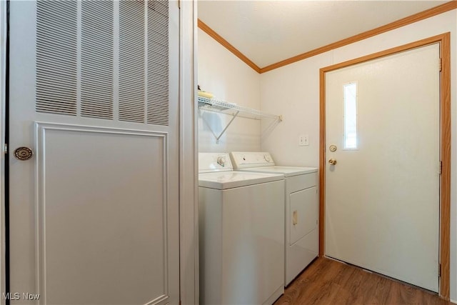 18592 Edwards Rd Unit 1, Doylestown, OH 44230 - washroom with a heating unit, washing machine and dryer, ornamental molding, and wood finished floors