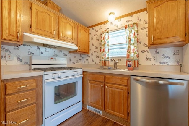 18592 Edwards Rd Unit 1, Doylestown, OH 44230 - kitchen featuring white gas range oven, stainless steel dishwasher, wallpapered walls, under cabinet range hood, and ornamental molding