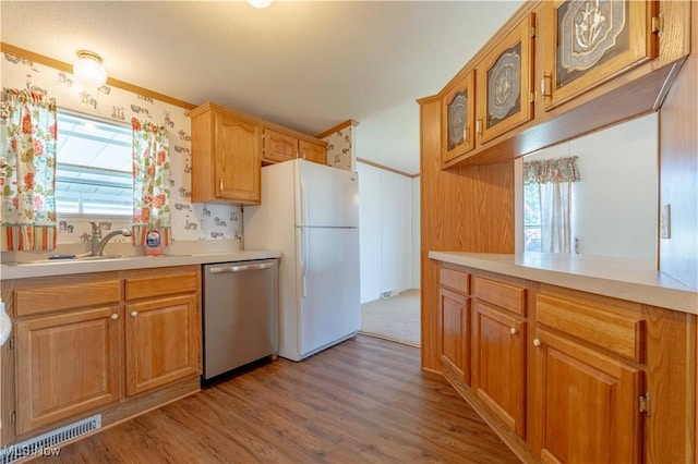 18592 Edwards Rd Unit 1, Doylestown, OH 44230 - kitchen featuring stainless steel dishwasher, freestanding refrigerator, glass insert cabinets, wood finished floors, and light countertops