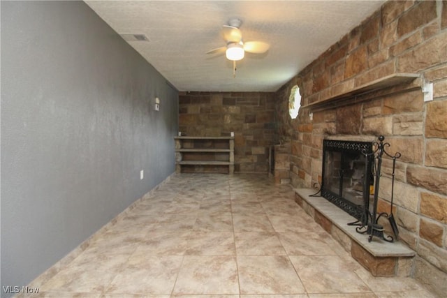 3316 S Canfield Niles Rd, Canfield, OH 44406 - unfurnished living room featuring a stone fireplace and ceiling fan