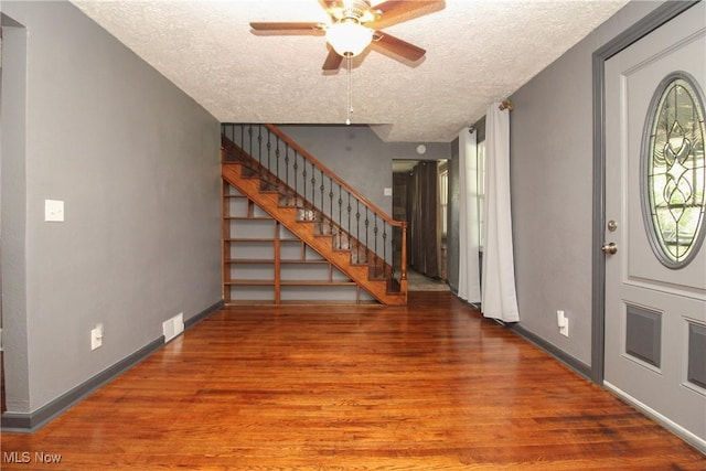 3316 S Canfield Niles Rd, Canfield, OH 44406 - foyer featuring a textured ceiling, a ceiling fan, wood finished floors, and stairway