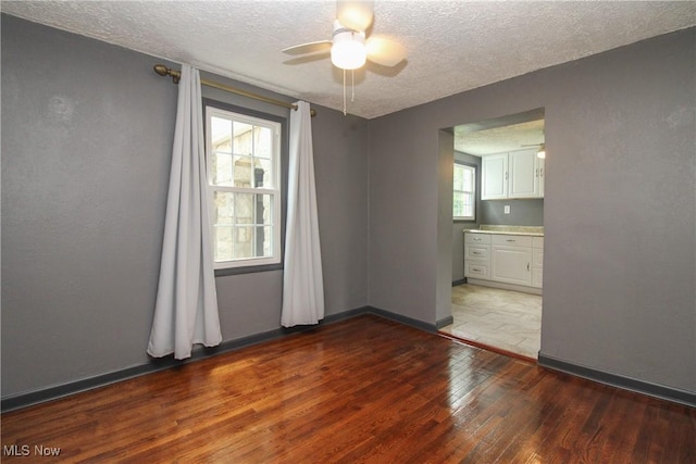 3316 S Canfield Niles Rd, Canfield, OH 44406 - spare room featuring a textured ceiling, hardwood / wood-style floors, and a ceiling fan