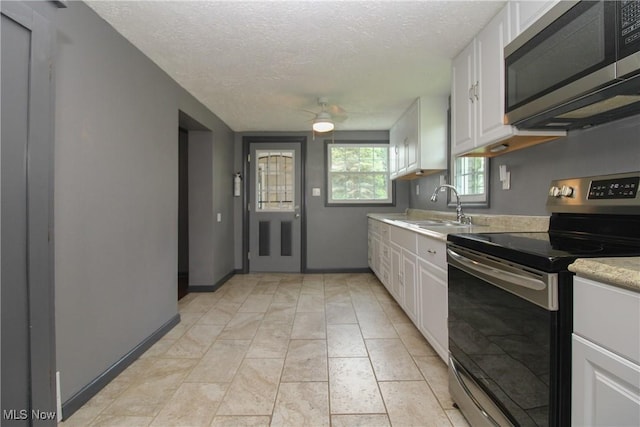 3316 S Canfield Niles Rd, Canfield, OH 44406 - kitchen featuring appliances with stainless steel finishes, light countertops, white cabinets, a textured ceiling, and ceiling fan