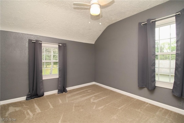 3316 S Canfield Niles Rd, Canfield, OH 44406 - unfurnished room with a textured ceiling, vaulted ceiling, ceiling fan, and carpet floors
