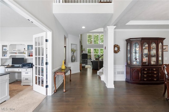 7319 Montella Ave NW, Canal Fulton, OH 44614 - entrance foyer featuring a wainscoted wall, wood finished floors, a decorative wall, crown molding, and ornate columns