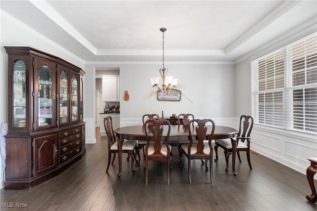 7319 Montella Ave NW, Canal Fulton, OH 44614 - dining room featuring a tray ceiling, a chandelier, a wainscoted wall, dark wood-type flooring, and a decorative wall
