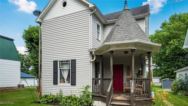 576 N Main St, Utica, OH 43080 - victorian home with covered porch, a front yard, and roof with shingles