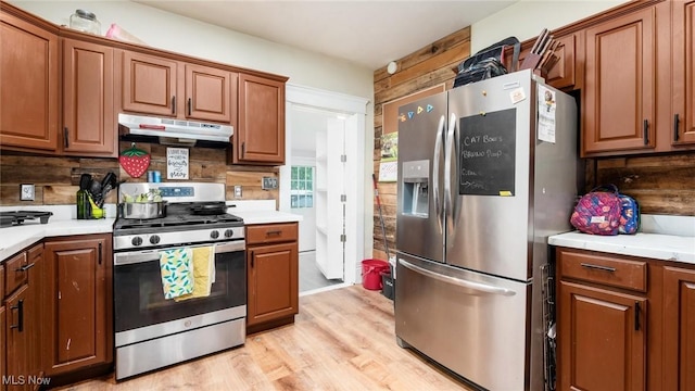 576 N Main St, Utica, OH 43080 - kitchen with appliances with stainless steel finishes, under cabinet range hood, light countertops, and light wood-style floors