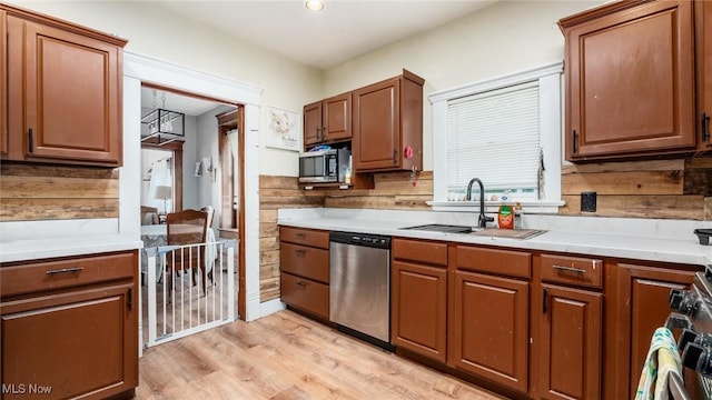 576 N Main St, Utica, OH 43080 - kitchen with stainless steel appliances, light countertops, light wood-style floors, and brown cabinets