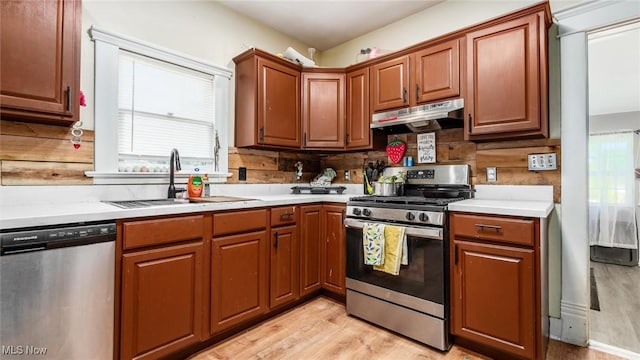 576 N Main St, Utica, OH 43080 - kitchen featuring stainless steel appliances, under cabinet range hood, light countertops, and light wood-type flooring