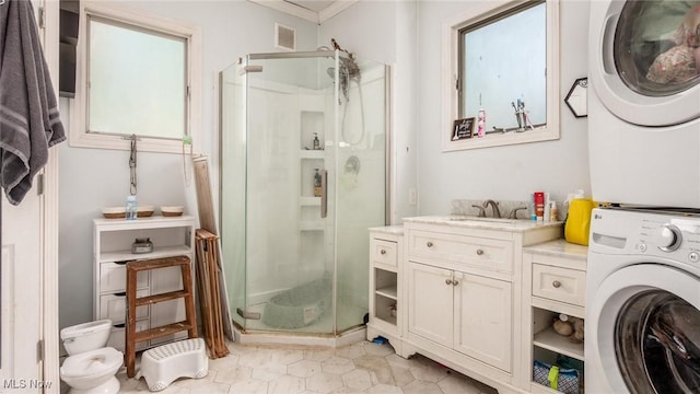 576 N Main St, Utica, OH 43080 - full bath with stacked washer and clothes dryer, a stall shower, ornamental molding, vanity, and tile patterned flooring