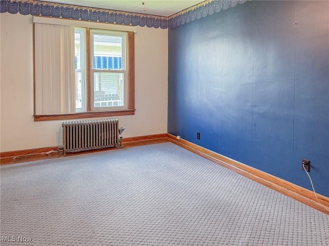 1120 N 5th St, Toronto, OH 43964 - carpeted empty room with radiator and baseboards