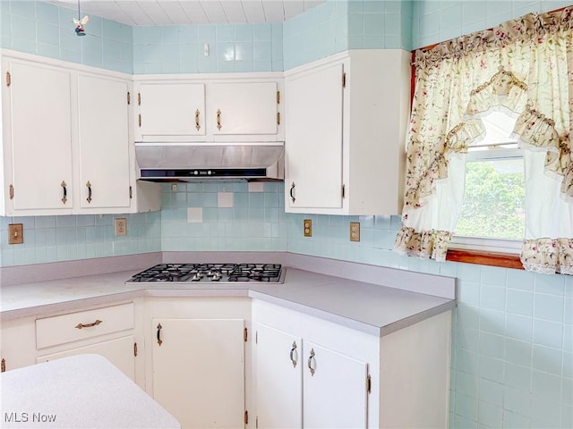 1120 N 5th St, Toronto, OH 43964 - kitchen with range hood, light countertops, white cabinetry, and stainless steel gas stovetop