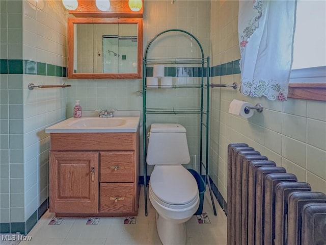 1120 N 5th St, Toronto, OH 43964 - bathroom featuring tile walls, radiator, vanity, and tile patterned floors