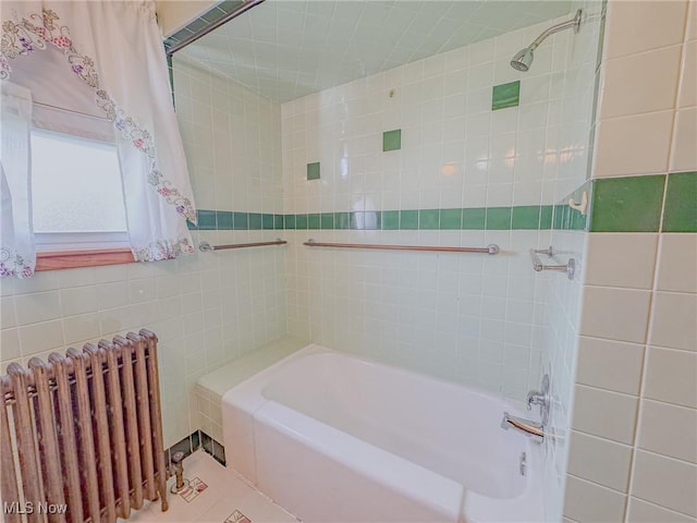 1120 N 5th St, Toronto, OH 43964 - bathroom with radiator, tile walls, tub / shower combination, and tile patterned flooring