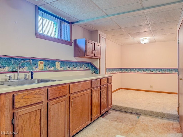 1120 N 5th St, Toronto, OH 43964 - kitchen featuring a drop ceiling, light colored carpet, light countertops, and brown cabinets