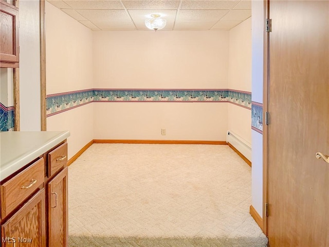 1120 N 5th St, Toronto, OH 43964 - spare room featuring carpet, a baseboard heating unit, and a drop ceiling