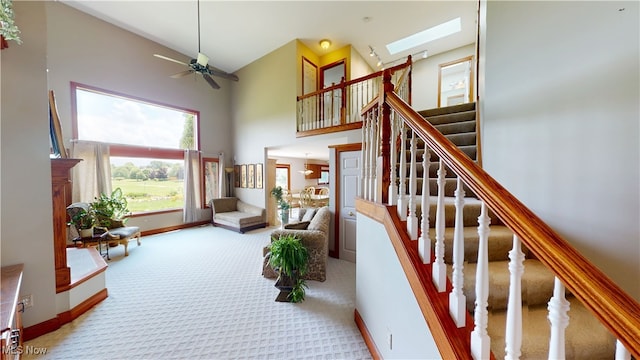 3383 Suffolk Downs, Stow, OH 44224 - staircase featuring carpet flooring, a towering ceiling, a skylight, and ceiling fan