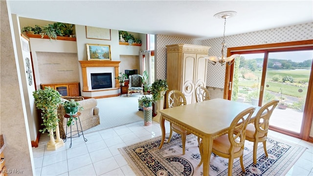 3383 Suffolk Downs, Stow, OH 44224 - dining area featuring wallpapered walls, a chandelier, light tile patterned floors, and a glass covered fireplace