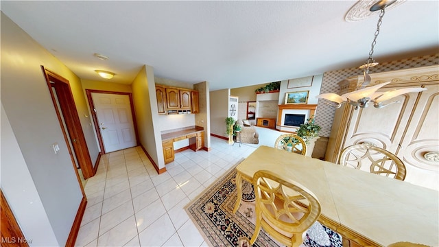 3383 Suffolk Downs, Stow, OH 44224 - dining area featuring a fireplace with raised hearth and light tile patterned floors