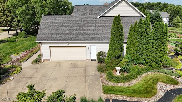 3383 Suffolk Downs, Stow, OH 44224 - view of side of property featuring a shingled roof, an attached garage, and driveway