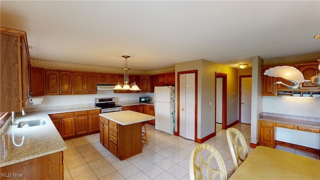 3383 Suffolk Downs, Stow, OH 44224 - kitchen with freestanding refrigerator, stainless steel electric stove, under cabinet range hood, light tile patterned floors, and a kitchen island