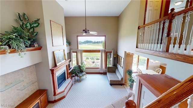 3383 Suffolk Downs, Stow, OH 44224 - foyer entrance with a towering ceiling, a fireplace, ceiling fan, and light carpet