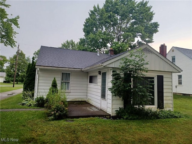 130 Fairground Blvd, Canfield, OH 44406 - rear view of property with a yard, roof with shingles, and board and batten siding