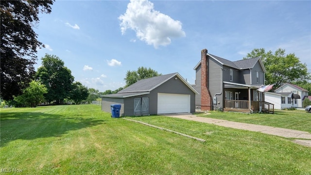 217 Mclaughlin Ave, Byesville, OH 43723 - view of home's exterior with an outdoor structure, a detached garage, a lawn, and a chimney