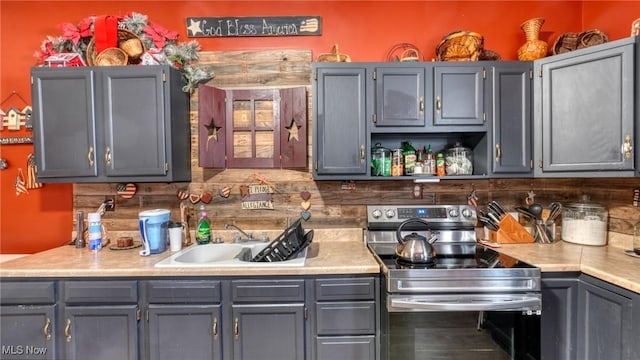 217 Mclaughlin Ave, Byesville, OH 43723 - kitchen with stainless steel electric stove, light countertops, gray cabinets, and open shelves