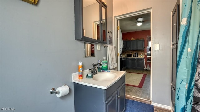 217 Mclaughlin Ave, Byesville, OH 43723 - bathroom featuring vanity, wood finished floors, and ceiling fan