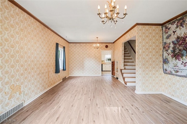 158 Elm St, Leetonia, OH 44431 - unfurnished living room with a chandelier, wallpapered walls, stairs, ornamental molding, and wood finished floors