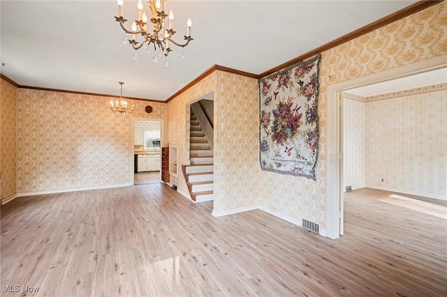 158 Elm St, Leetonia, OH 44431 - unfurnished living room featuring a chandelier, wallpapered walls, stairway, wood finished floors, and ornamental molding