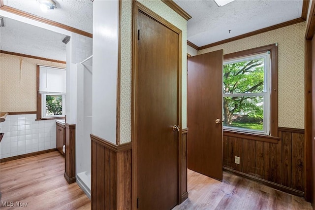 158 Elm St, Leetonia, OH 44431 - hall with a wainscoted wall, a textured ceiling, ornamental molding, light wood-type flooring, and wallpapered walls
