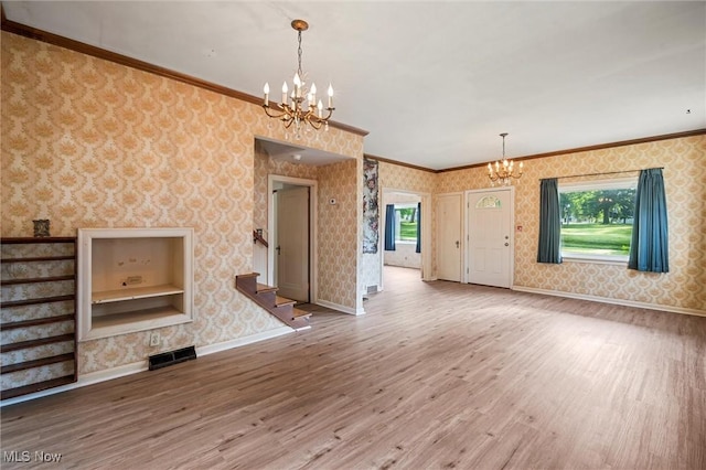 158 Elm St, Leetonia, OH 44431 - unfurnished living room with a chandelier, wallpapered walls, wood finished floors, stairway, and ornamental molding