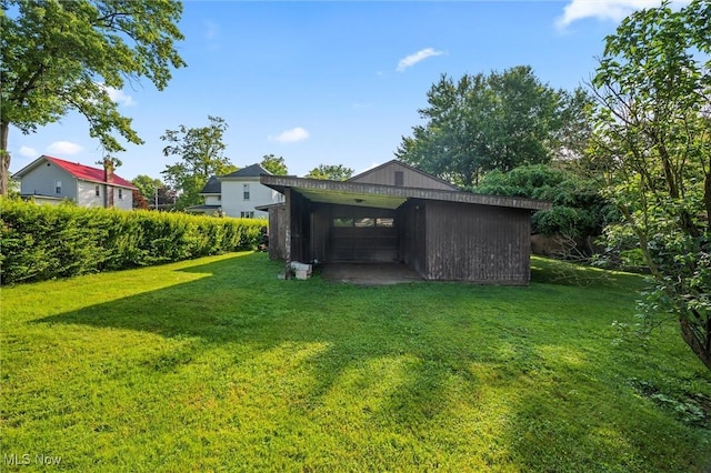 158 Elm St, Leetonia, OH 44431 - view of green lawn featuring a garage and an outdoor structure