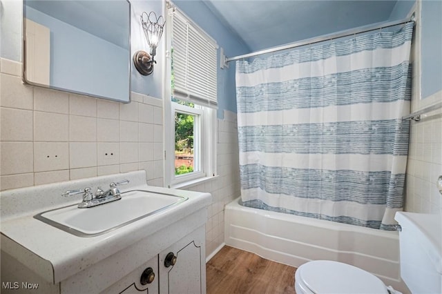 158 Elm St, Leetonia, OH 44431 - bathroom with tile walls, vanity, shower / bath combination with curtain, and wood finished floors