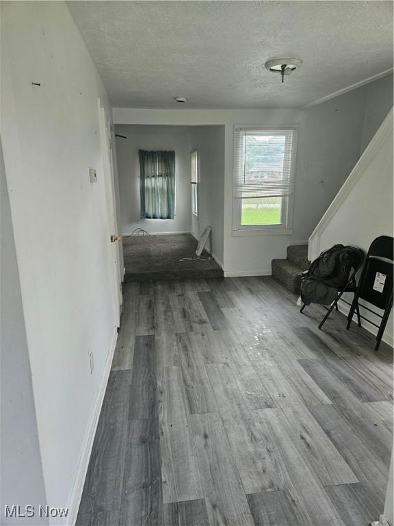 5860 Kirk Rd, Canfield, OH 44406 - corridor featuring stairway, a textured ceiling, and wood finished floors