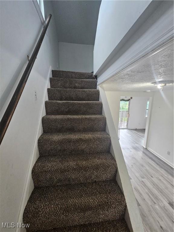 5860 Kirk Rd, Canfield, OH 44406 - staircase with wood finished floors and baseboards