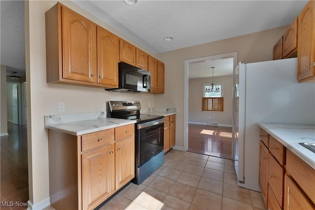 233 Robbies Run, Cortland, OH 44410 - kitchen with stainless steel electric stove, black microwave, a textured ceiling, light stone counters, and light tile patterned flooring