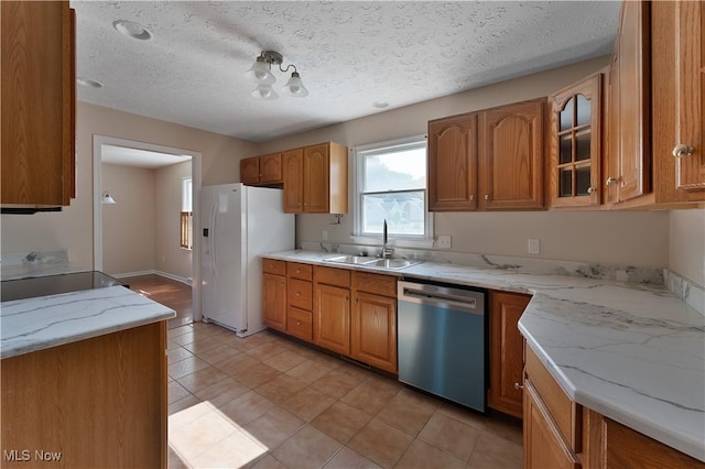 233 Robbies Run, Cortland, OH 44410 - kitchen with stainless steel dishwasher, white refrigerator with ice dispenser, glass insert cabinets, a textured ceiling, and brown cabinetry
