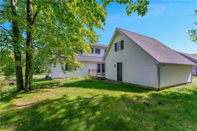 233 Robbies Run, Cortland, OH 44410 - rear view of house with a yard and roof with shingles