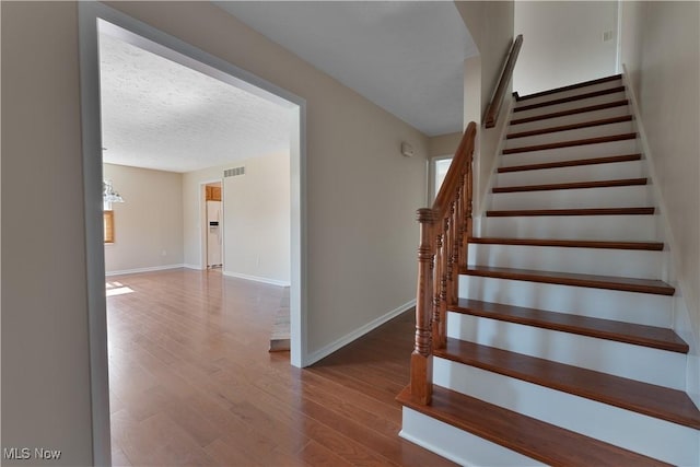 233 Robbies Run, Cortland, OH 44410 - stairway with wood finished floors and a textured ceiling