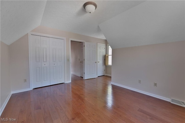 233 Robbies Run, Cortland, OH 44410 - bonus room with lofted ceiling, wood finished floors, and a textured ceiling