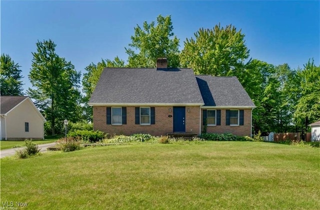 233 Robbies Run, Cortland, OH 44410 - view of front facade featuring a front lawn, a chimney, and brick siding