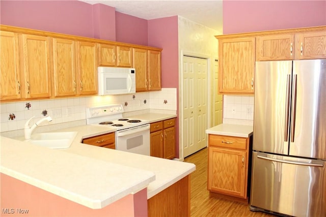 9 Hunters Woods Blvd Unit B, Canfield, OH 44406 - kitchen with white appliances, light wood-style flooring, light countertops, and decorative backsplash