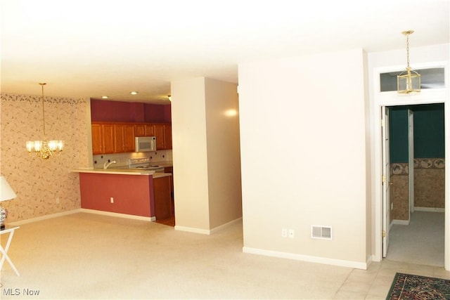9 Hunters Woods Blvd Unit B, Canfield, OH 44406 - unfurnished living room featuring a chandelier, light carpet, and wallpapered walls