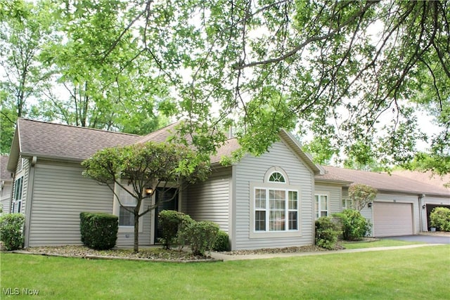 9 Hunters Woods Blvd Unit B, Canfield, OH 44406 - ranch-style home featuring a garage, a front lawn, driveway, and a shingled roof