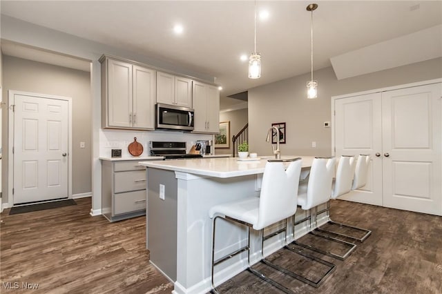 864 Woodside Dr, Westlake, OH 44145 - kitchen featuring stainless steel appliances, gray cabinets, light countertops, and dark wood-style flooring