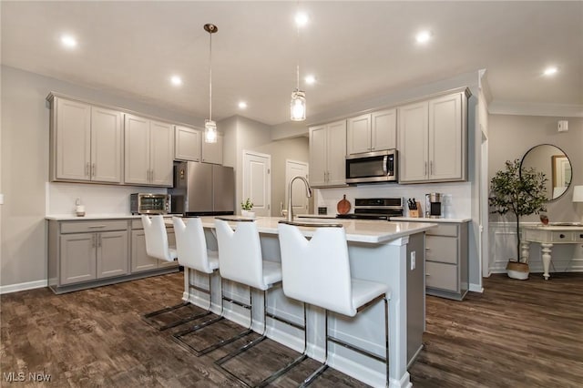 864 Woodside Dr, Westlake, OH 44145 - kitchen featuring stainless steel appliances, dark wood-style flooring, a kitchen island with sink, light countertops, and recessed lighting